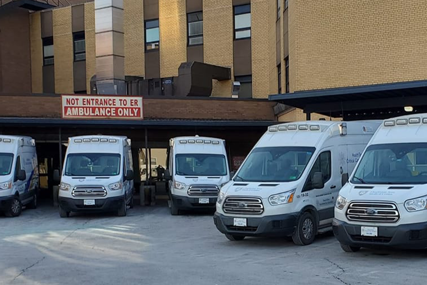 An image of multiple HealthTeam Critical Care Transport ambulances